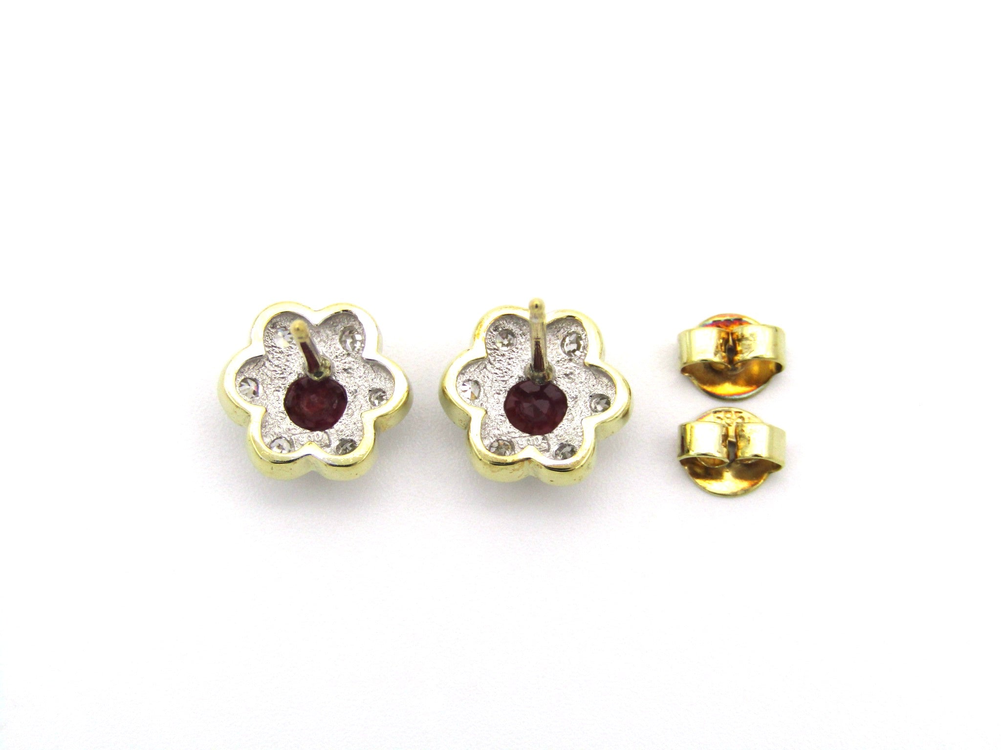 14K gold ruby and diamond flower earrings.