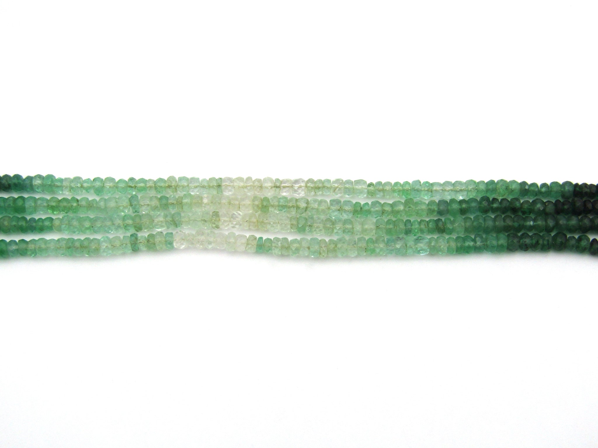 Silver 4-strand emerald and green beryl necklace.