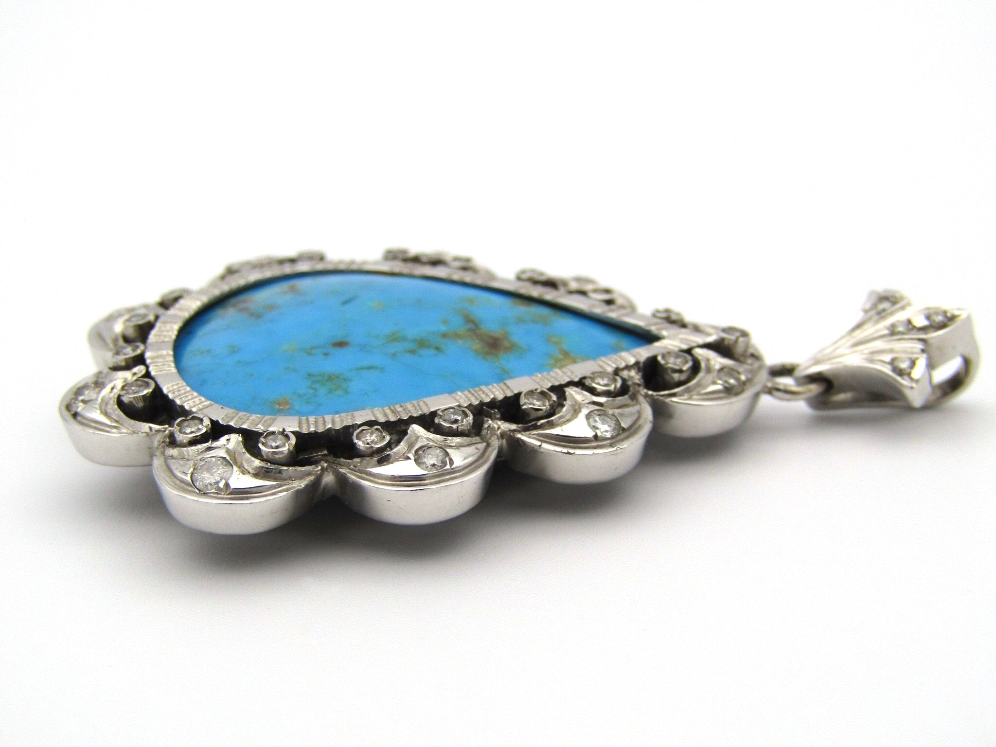 18kt white gold turquoise and diamond pendant.