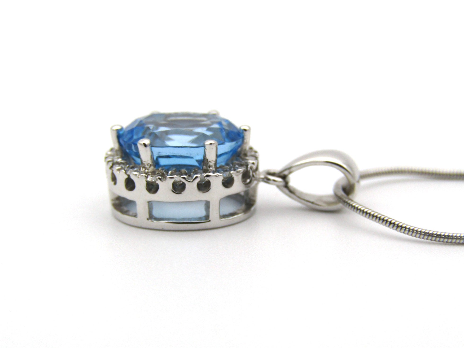 9K gold blue topaz and diamond pendant.