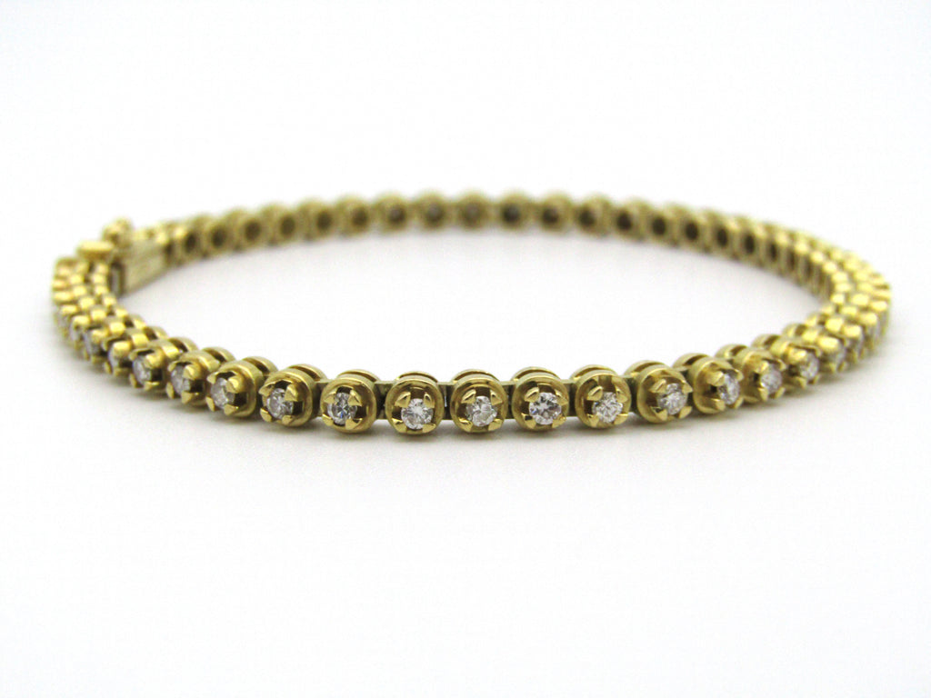 18kt gold diamond tennis bracelet.