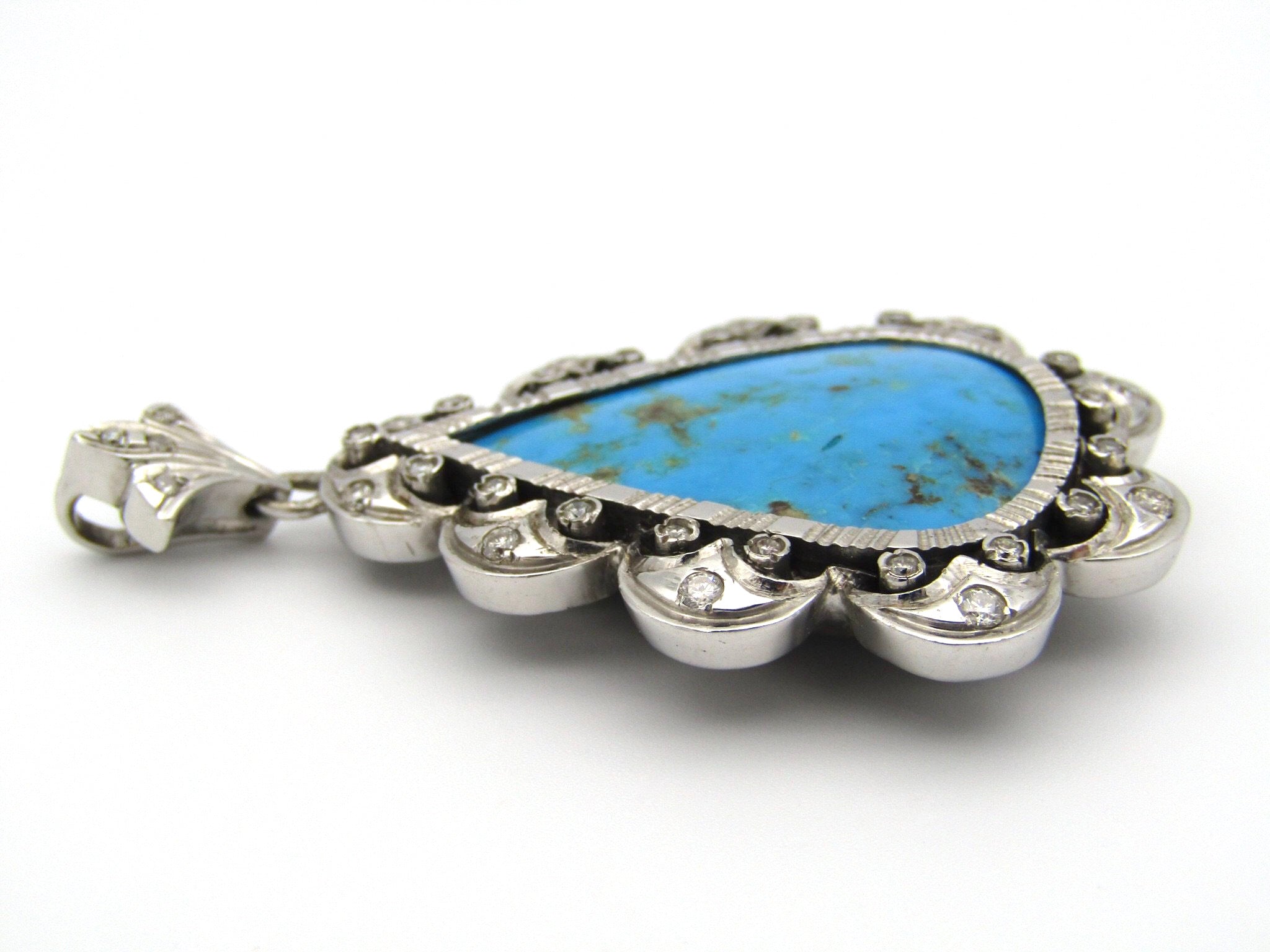 18kt white gold turquoise and diamond pendant.