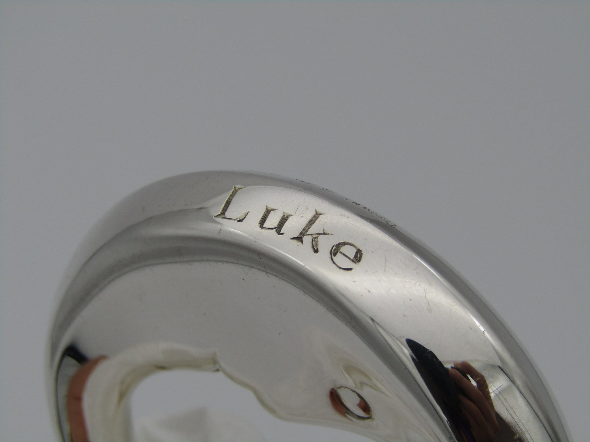 Tiffany & Co. sterling silver "Man in the moon" baby rattle. With the name "Luke" engraved on the rim.