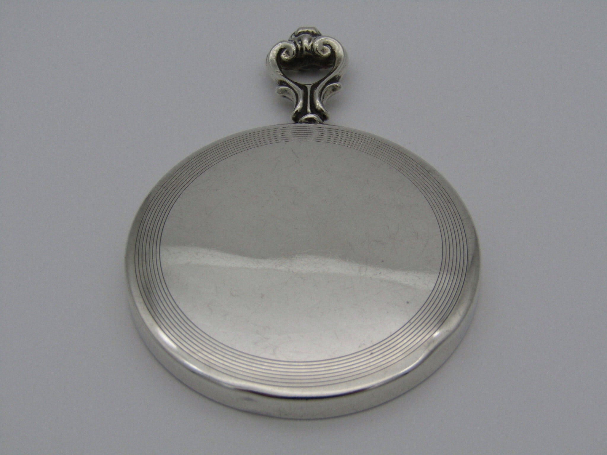 A sterling silver hand mirror by Cartier. Circa 1920s.